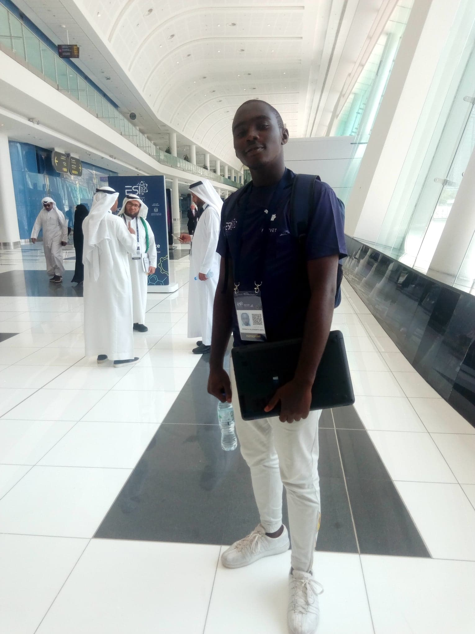 Full-length photograph on the exhibition concourse beneath the ESI 2019 signage.